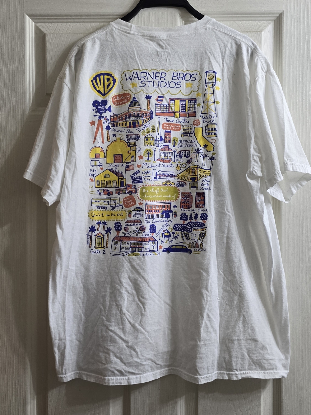 Warner Bros. White Short Sleeve Tee with Yellow & Blue Studio Graphic